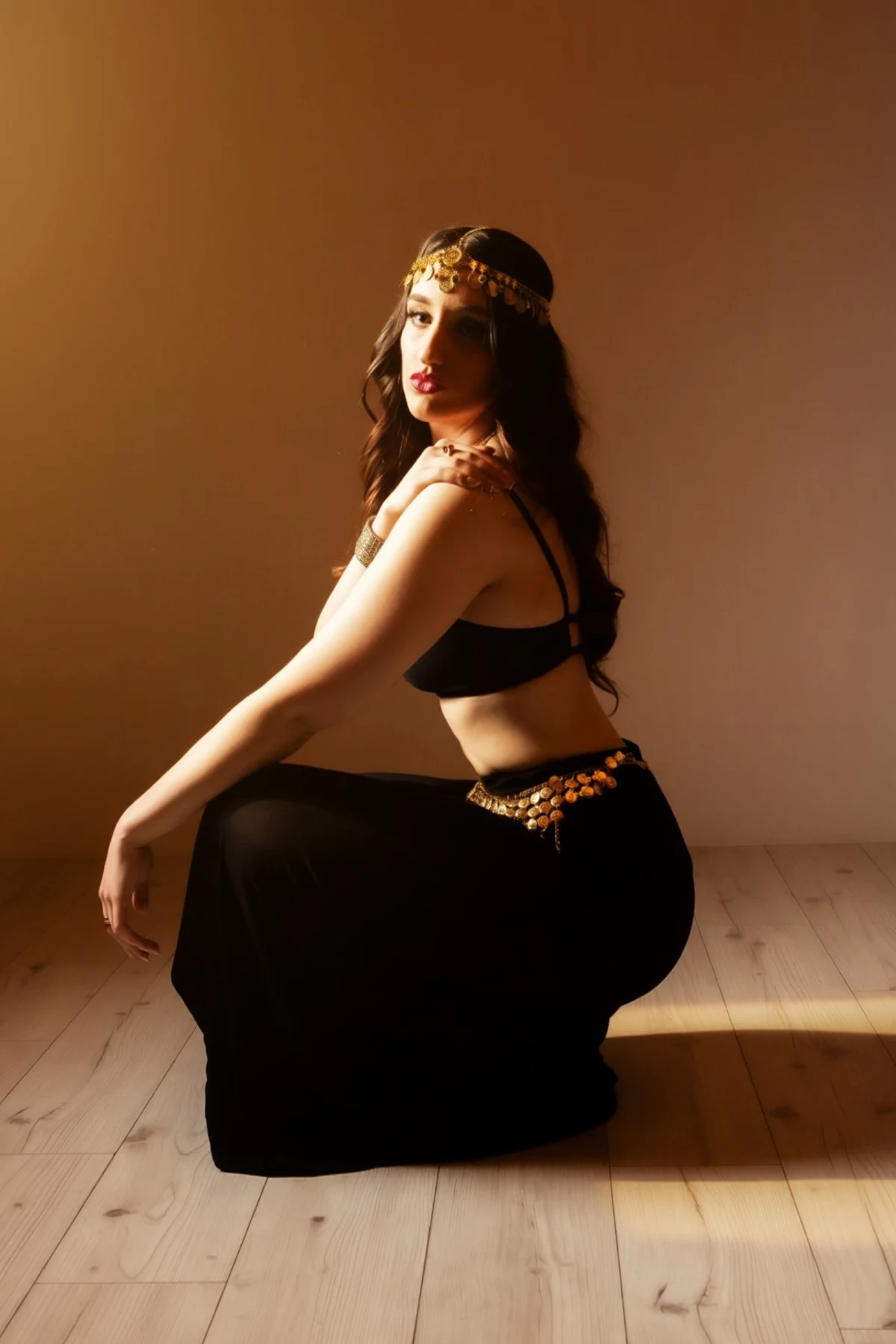 Nishka seated, looking over her shoulder