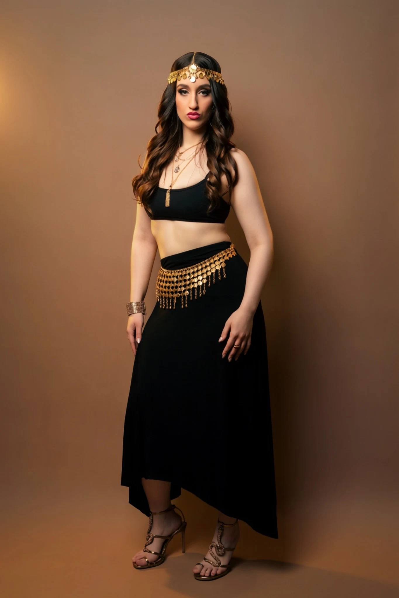 Full-length portrait of Nishka in black and gold
