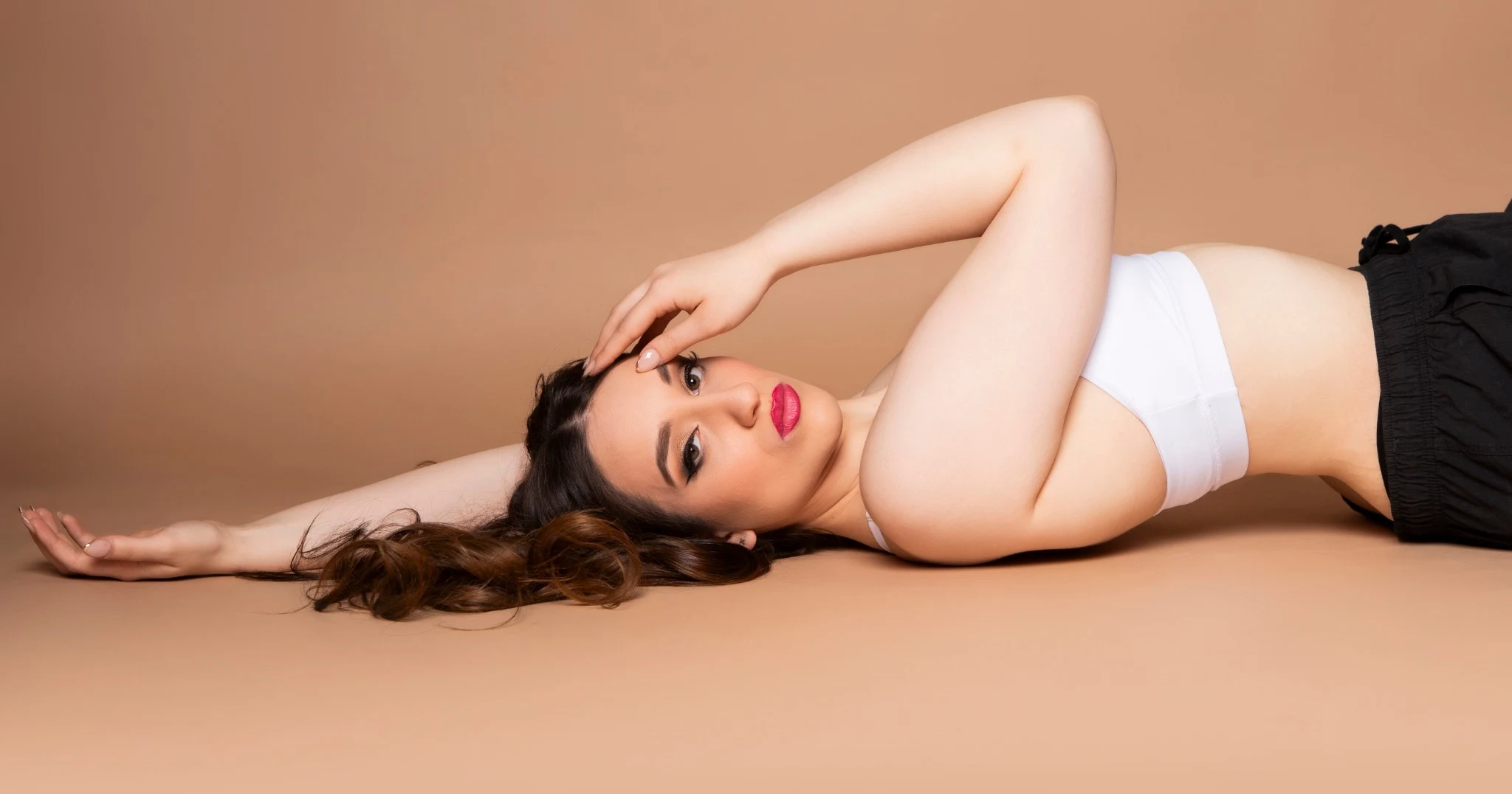 Nishka reclining in a white top