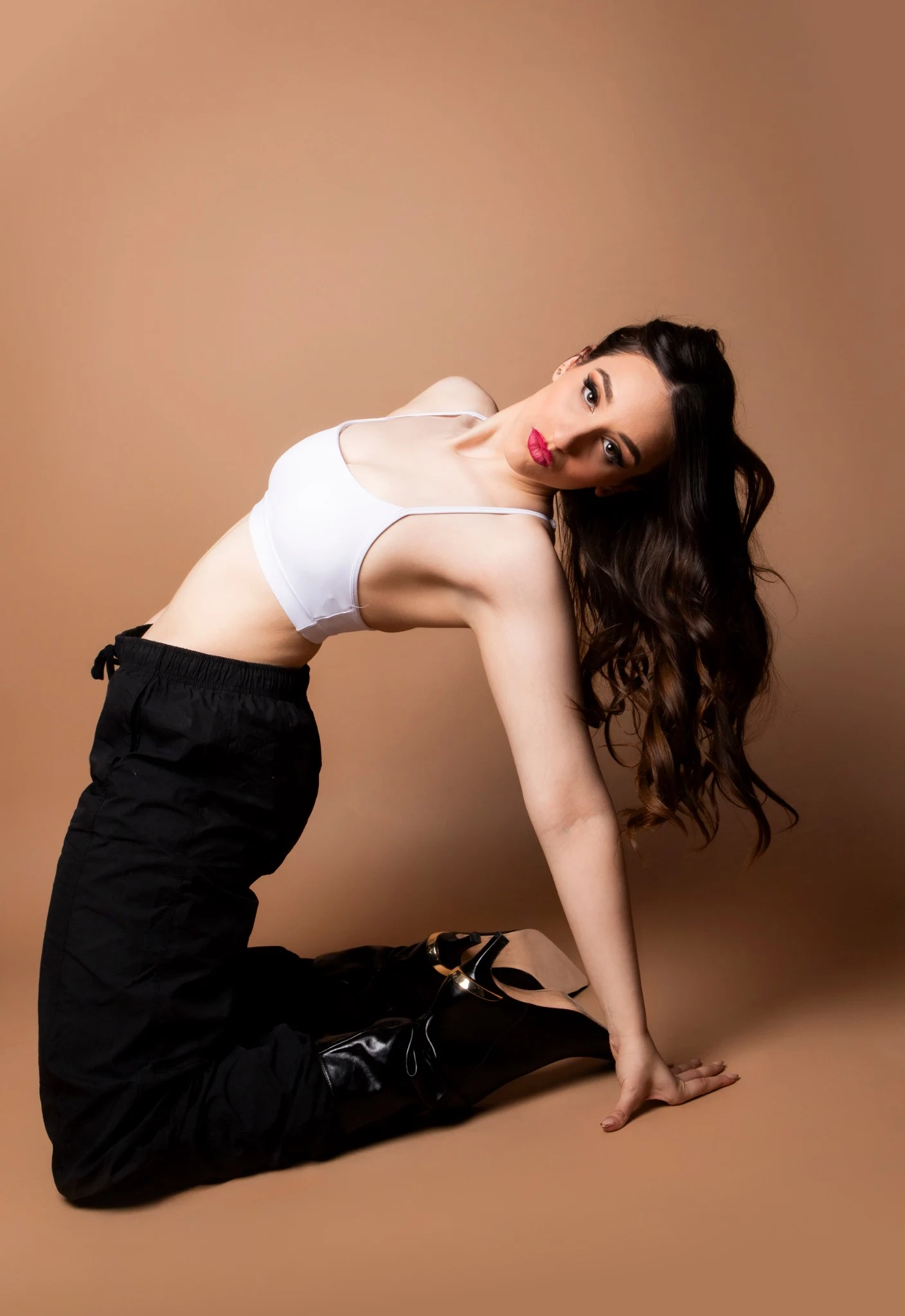 Nishka kneeling in an arched pose
